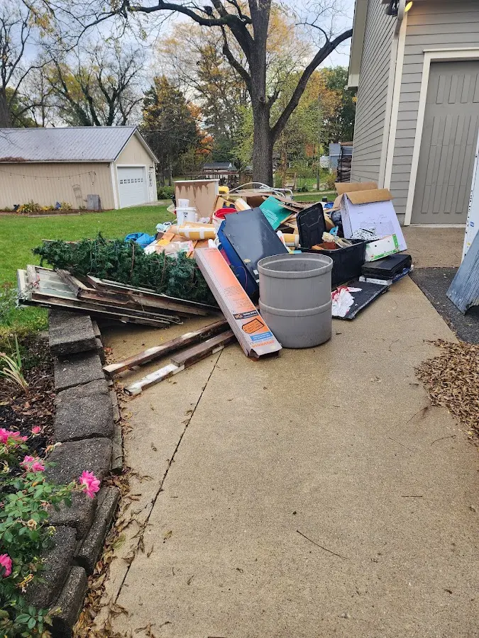 Dumpster being loaded with debris for 12 Yard Dumpster Rental in West Allis